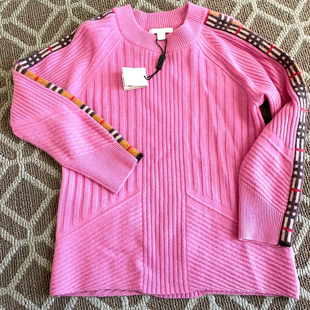 Pink Burberry sweater with plaid stripe on arms.